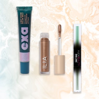 Best Liquid Eye Shadows: a collaged image of Exa Light Show Color Melt, Ilia Chromatic Eye Tint, and Huda Beauty Matte & Metal Melted Shadows on a marbled peach and blue background
