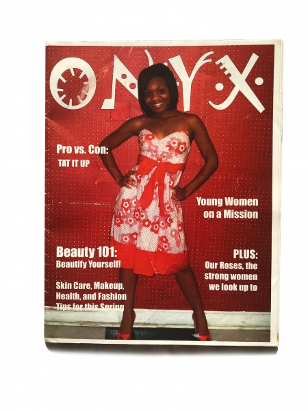A photo of the ONYX magazine with editor and chief Jessica Cruel on the cover wearing a red dress and heels